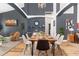 Modern dining room with wooden table, black accent wall, and a stylish chandelier at 421 Boxwood Dr, Davenport, FL 33837