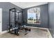 Home gym featuring weight rack and equipment setup with natural light from a large window, enhancing the workout atmosphere at 421 Boxwood Dr, Davenport, FL 33837