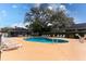 Community pool surrounded by lounge chairs and well-maintained landscape providing a relaxing and recreational amenity at 421 Boxwood Dr, Davenport, FL 33837