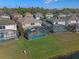 Houses with pools along a lake in a residential community at 4700 Golden Beach Ct, Kissimmee, FL 34746