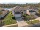 Two-story house with tan exterior, white garage door, and a lake view at 4700 Golden Beach Ct, Kissimmee, FL 34746