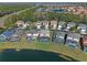 Aerial view of homes with private pools, community lake, and lush landscaping at 4700 Golden Beach Ct, Kissimmee, FL 34746