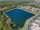 Aerial view of a lake surrounded by homes and conservation at 4700 Golden Beach Ct, Kissimmee, FL 34746