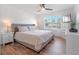 Bright bedroom with queen-size bed and wood-look floors at 4700 Golden Beach Ct, Kissimmee, FL 34746