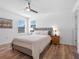 Cozy bedroom with queen-size bed, nightstands, and wood-look floors at 4700 Golden Beach Ct, Kissimmee, FL 34746