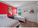 Mickey Mouse themed bedroom with twin beds, and a red accent wall at 4700 Golden Beach Ct, Kissimmee, FL 34746