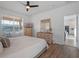 Main bedroom with large bed, crib, dresser, and view of kitchen at 4700 Golden Beach Ct, Kissimmee, FL 34746