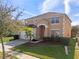 Two-story house with a tan exterior and a two-car garage at 4700 Golden Beach Ct, Kissimmee, FL 34746