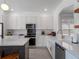 Modern kitchen with island, white cabinets, and a farmhouse sink at 4700 Golden Beach Ct, Kissimmee, FL 34746