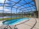 Relaxing screened-in pool with lake view at 4700 Golden Beach Ct, Kissimmee, FL 34746