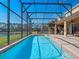 Inviting screened-in pool with a view of the lake at 4700 Golden Beach Ct, Kissimmee, FL 34746