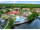 Aerial view of community pool, clubhouse, and surrounding landscape at 4700 Golden Beach Ct, Kissimmee, FL 34746