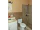 Bathroom with shower, toilet, and brown tile at 477 C St # 4, Casselberry, FL 32707