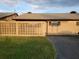 Exterior view of a single-story home with a grassy yard and block wall at 477 C St # 4, Casselberry, FL 32707