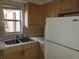 Kitchen with light wood cabinets and Whirlpool refrigerator at 477 C St # 4, Casselberry, FL 32707