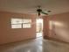 Living room with pink walls, tile floor, and ceiling fan at 477 C St # 4, Casselberry, FL 32707