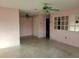 Living room with pink walls, two ceiling fans, and a view of the bathroom at 477 C St # 4, Casselberry, FL 32707