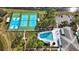 Aerial view of community basketball and tennis courts along with a swimming pool at 4817 Gallant Ln, Orlando, FL 32821