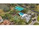 An aerial view captures the community pool, tennis courts, shuffleboard, and clubhouse by a pond and lush landscaping at 4817 Gallant Ln, Orlando, FL 32821