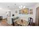 Bright dining area with wood floors, stylish lighting, and comfortable seating at the kitchen island at 4817 Gallant Ln, Orlando, FL 32821