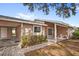 Charming single-story home with a connected carport, covered porch, and manicured shrubbery at 4817 Gallant Ln, Orlando, FL 32821