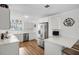 Modern white kitchen with stainless steel appliances, quartz countertops, and a breakfast bar at 4817 Gallant Ln, Orlando, FL 32821