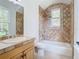 Bathroom with tiled shower and bathtub, plus updated vanity at 5067 Latrobe Dr, Windermere, FL 34786