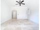 Bright and airy bedroom with travertine flooring and an arched doorway at 5067 Latrobe Dr, Windermere, FL 34786