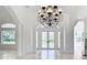 Bright dining room with chandelier and French doors to backyard at 5067 Latrobe Dr, Windermere, FL 34786