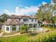 Exterior view of a house with a backyard pool and large lawn at 5067 Latrobe Dr, Windermere, FL 34786