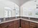 Kitchen features granite countertop and custom cabinetry at 5067 Latrobe Dr, Windermere, FL 34786