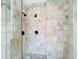 Large walk-in shower with multiple shower heads and stone tile at 5067 Latrobe Dr, Windermere, FL 34786