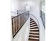 Grand curved staircase with wrought iron railing at 5067 Latrobe Dr, Windermere, FL 34786