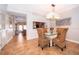 Dining room with glass table, wicker chairs, and kitchen view at 5409 Napoli Cv, Lake Mary, FL 32746