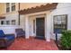 Front patio with brick flooring and wicker chairs at 5409 Napoli Cv, Lake Mary, FL 32746