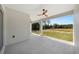 Covered backyard patio with concrete floor and ceiling fans offering outdoor relaxation space overlooking a grassy yard at 5544 Sw 136Th Ave, Ocala, FL 34481