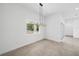 Bright dining room features modern chandelier, large window and tile flooring at 5544 Sw 136Th Ave, Ocala, FL 34481