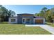 Contemporary single-story home featuring a modern gray and white facade and well-manicured lawn at 5544 Sw 136Th Ave, Ocala, FL 34481