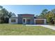 Contemporary single-story home featuring a modern gray and white facade and well-manicured lawn at 5544 Sw 136Th Ave, Ocala, FL 34481