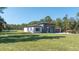 Modern home exterior with a well-manicured lawn, showcasing its contemporary design and serene outdoor setting at 5544 Sw 136Th Ave, Ocala, FL 34481