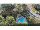 Aerial view of a community pool surrounded by lush greenery and palm trees at 564 Shadow Glenn Pl, Winter Springs, FL 32708