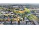 Aerial view showcasing townhomes with community green spaces, tree-lined streets and neighborhood amenities at 564 Shadow Glenn Pl, Winter Springs, FL 32708