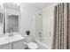 Bathroom featuring a shower-tub combo with tile, a decorative mirror, and an updated vanity at 564 Shadow Glenn Pl, Winter Springs, FL 32708