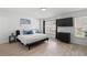 Bedroom with tile floors, large window and flatscreen TV at 564 Shadow Glenn Pl, Winter Springs, FL 32708