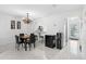 Chandelier-lit dining space includes a view to the entry and an opening to the kitchen at 564 Shadow Glenn Pl, Winter Springs, FL 32708