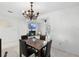 Bright dining room features modern chandelier and flows into adjacent living area with fireplace at 564 Shadow Glenn Pl, Winter Springs, FL 32708