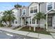 Charming townhome featuring lush landscaping, palm trees, and a welcoming front entrance at 564 Shadow Glenn Pl, Winter Springs, FL 32708