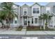 Exterior view of gray townhome with palm trees and tidy landscaping at 564 Shadow Glenn Pl, Winter Springs, FL 32708