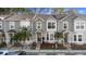 Exterior view of townhomes featuring gray siding, well-manicured landscaping, and inviting entrances at 564 Shadow Glenn Pl, Winter Springs, FL 32708