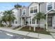 Charming townhome featuring a well-maintained front yard with palm trees and a welcoming entrance at 564 Shadow Glenn Pl, Winter Springs, FL 32708